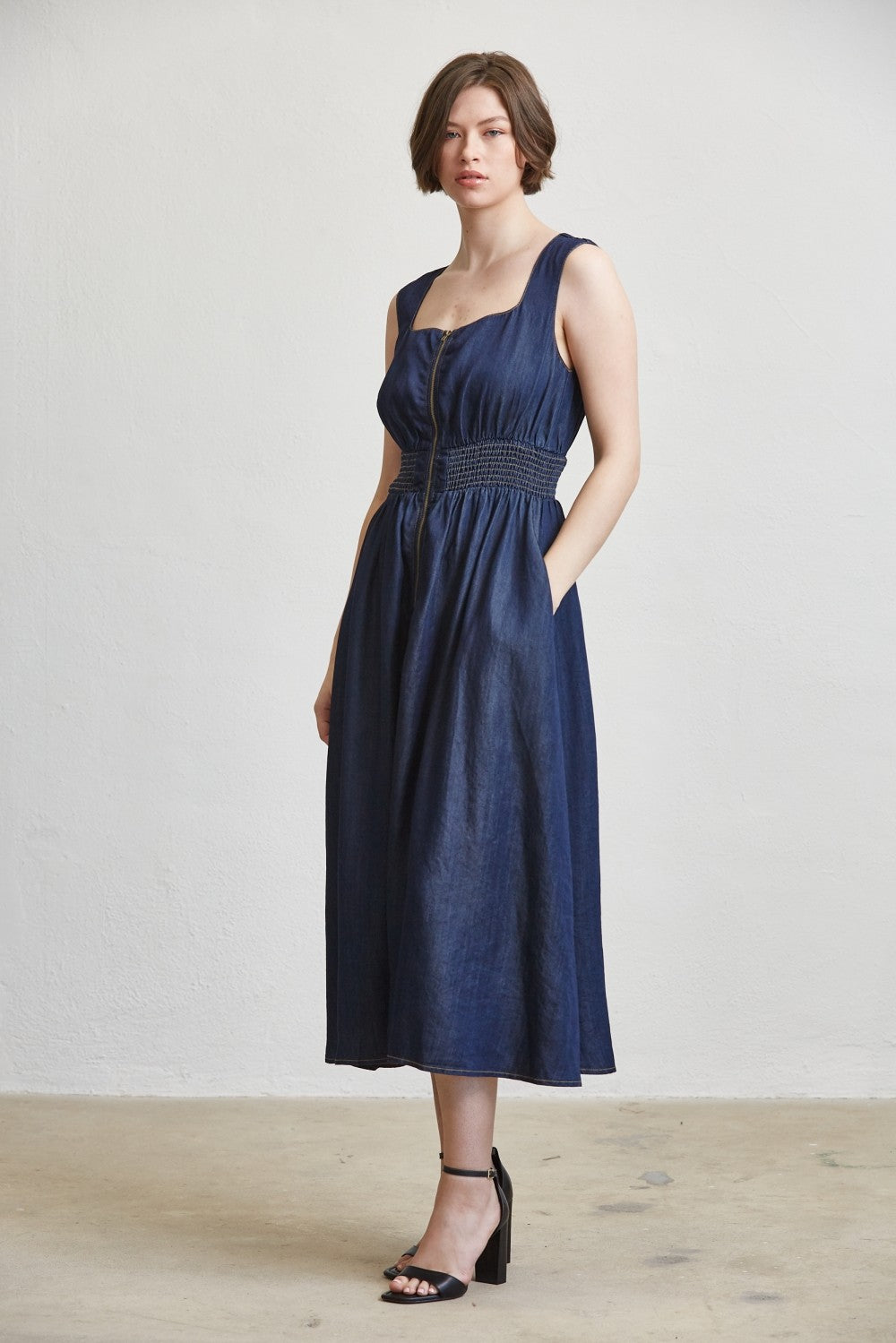 SLEEVELESS SMOCKED WAIST ZIP FRONT MIDI DRESS--DK. DENIM